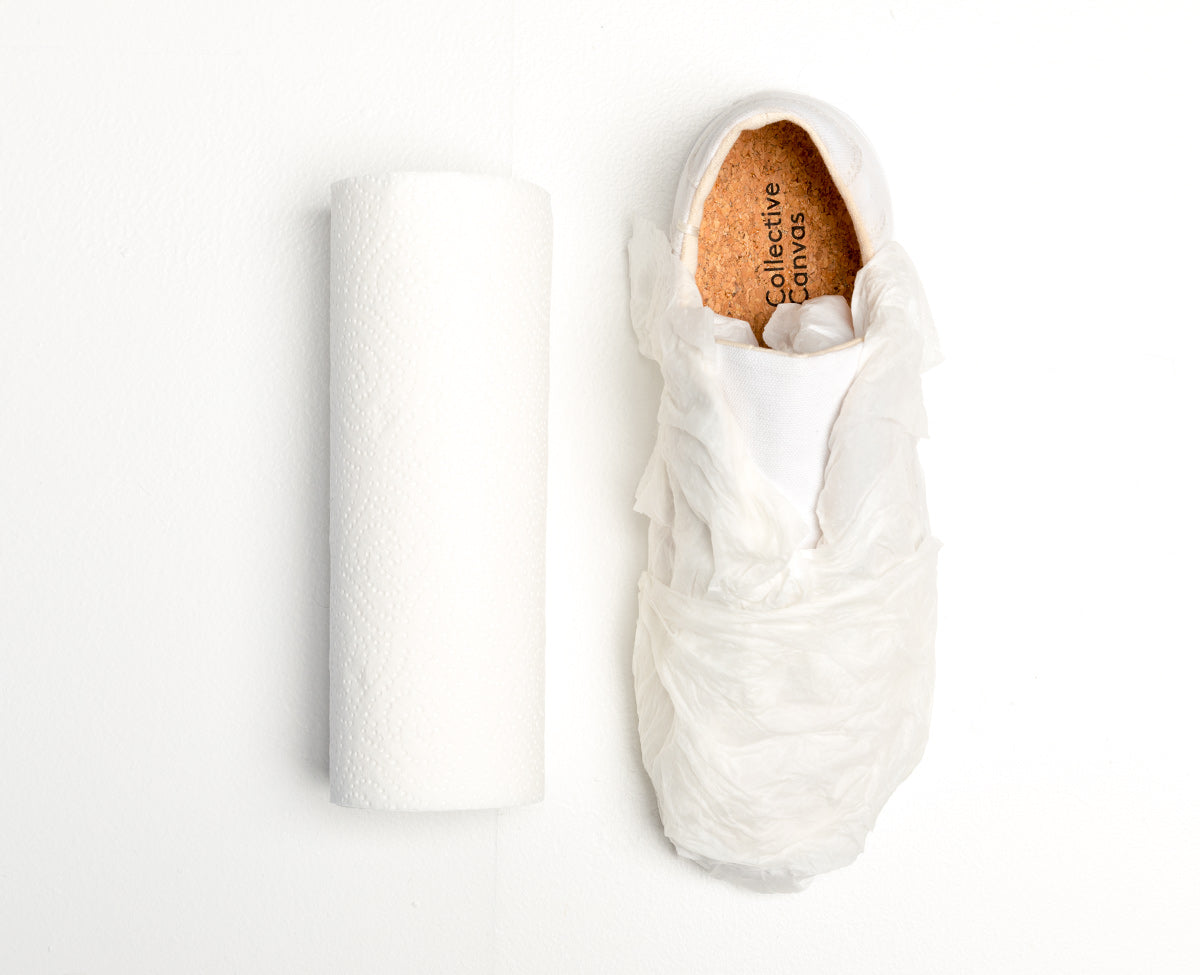 White Collective Canvas trainer wrapped in damp paper towel.