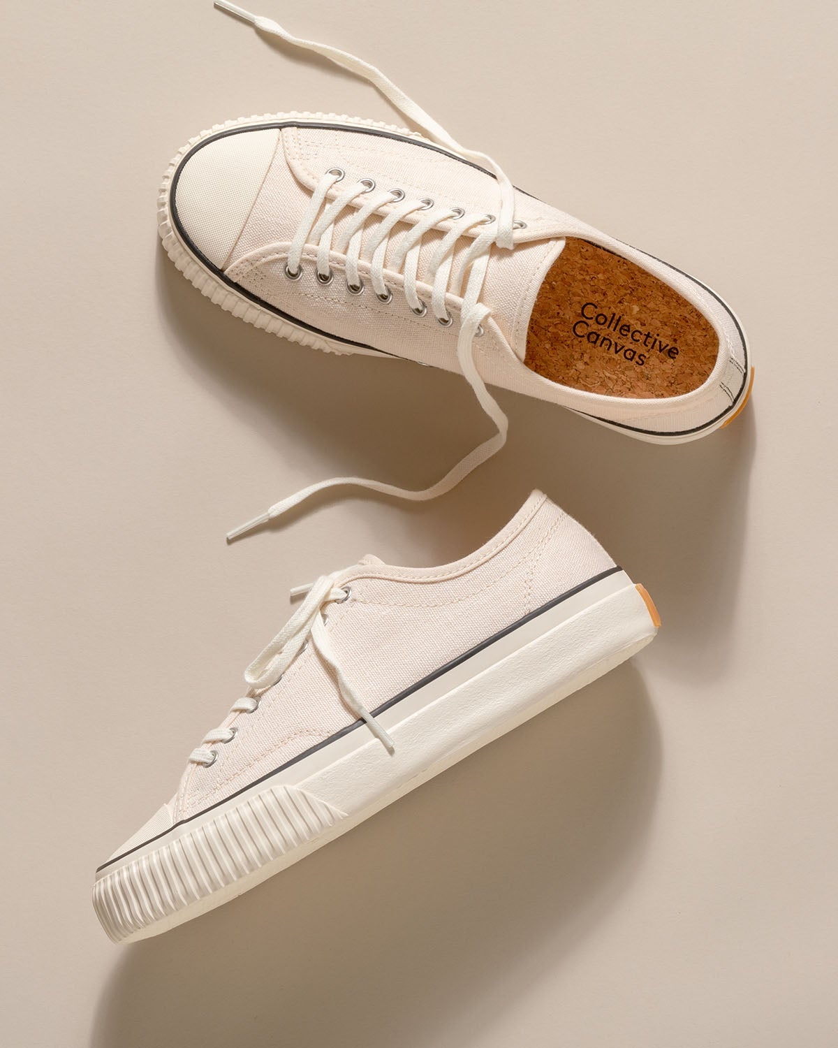 Straat Hemp Natural/Black trainers laid flat on a beige backdrop, one showing its cork insole