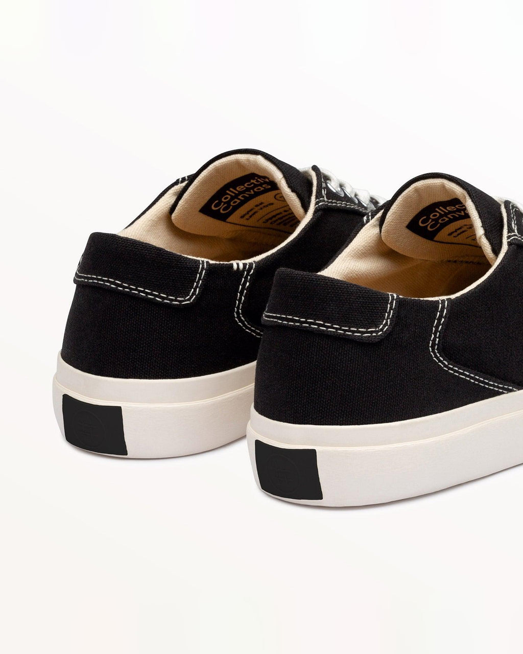 Close-up of Bal Black/White heel with stitched pull tab and black heel patch on the off-white rubber sole