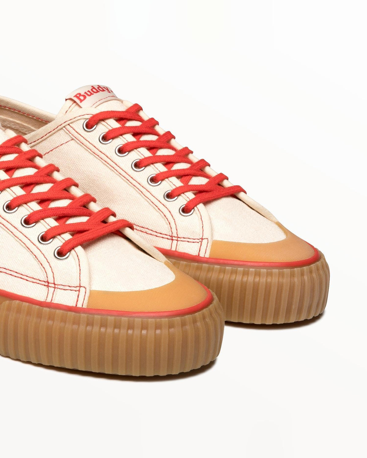Close-up of off-white hemp canvas upper, red laces and natural gum rubber toe caps on Buddy x CC Off-White/Red