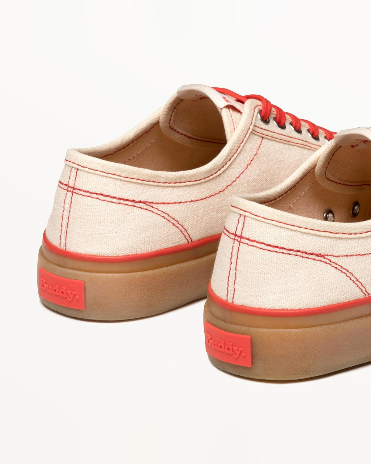 Close-up of Buddy x CC Off-White/Red heels with red Buddy tab on the natural gum rubber sole