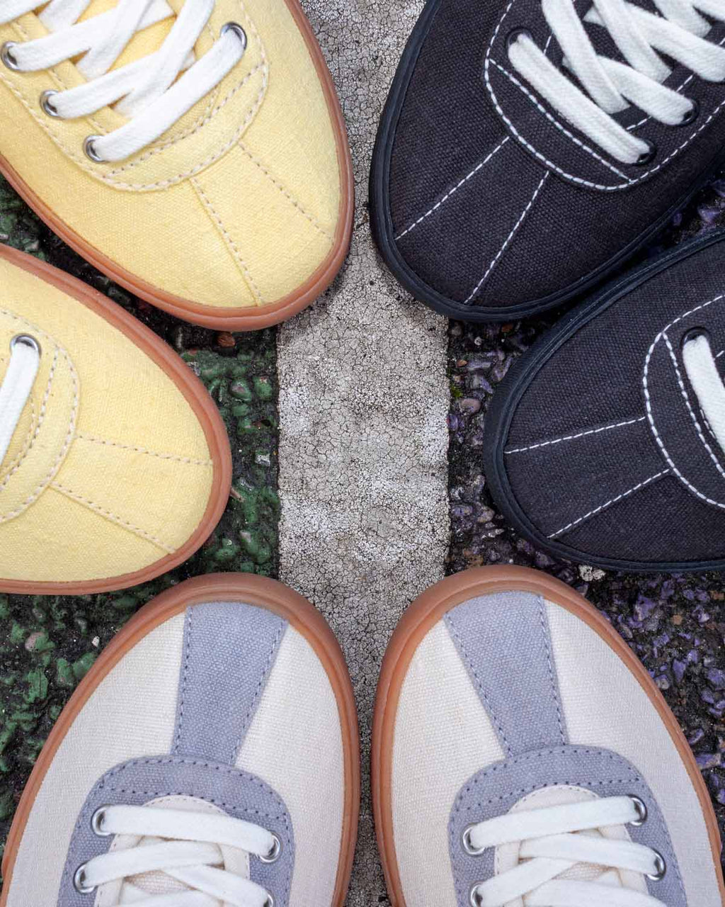 Looper Hemp trainers in Butter/Ecru, Black/White Stitch and Ecru/Grey arranged toe to toe on pavement