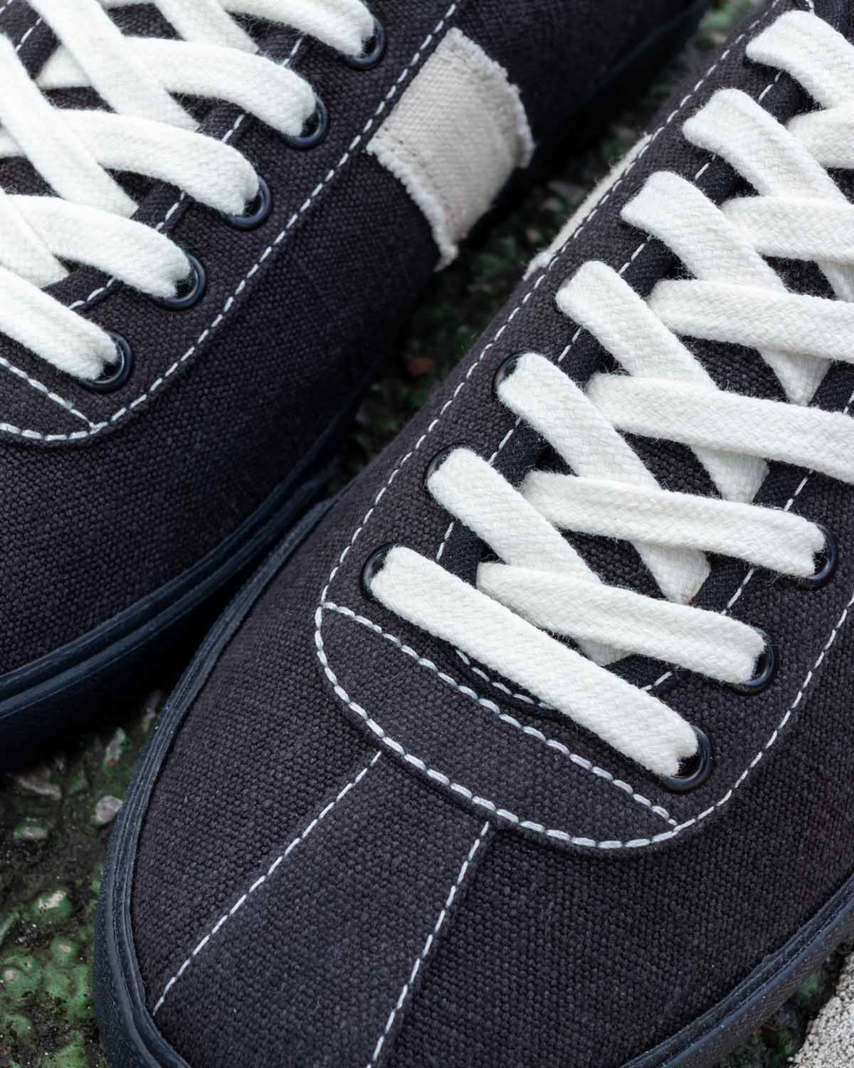 Close-up of Looper Hemp Black/White Stitch toes showing white contrast stitching and white laces