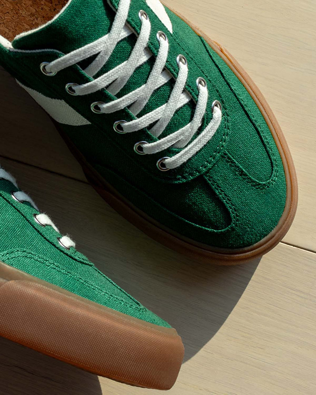 Close-up of Veld Hemp Sage/Ecru trainers from above on a light wooden floor