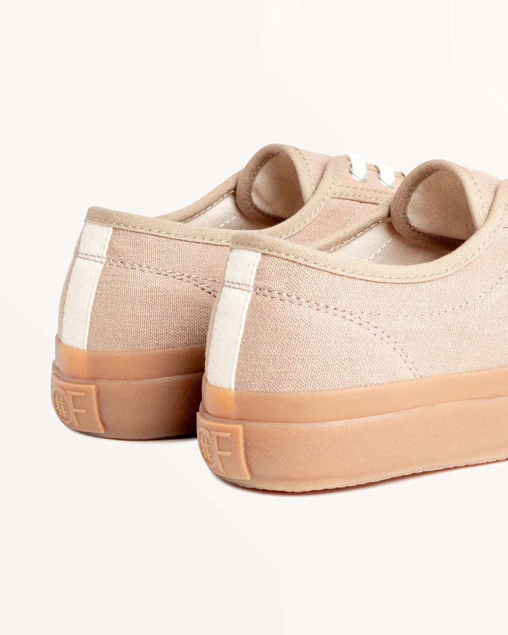 Close-up of CC x Original Fibres Greige heels with embossed OF logo on the natural gum rubber sole
