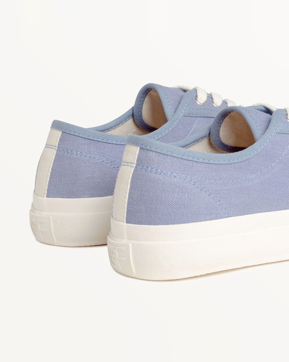 Close-up of CC x Original Fibres Stonewash heels with embossed OF logo on the off-white rubber sole