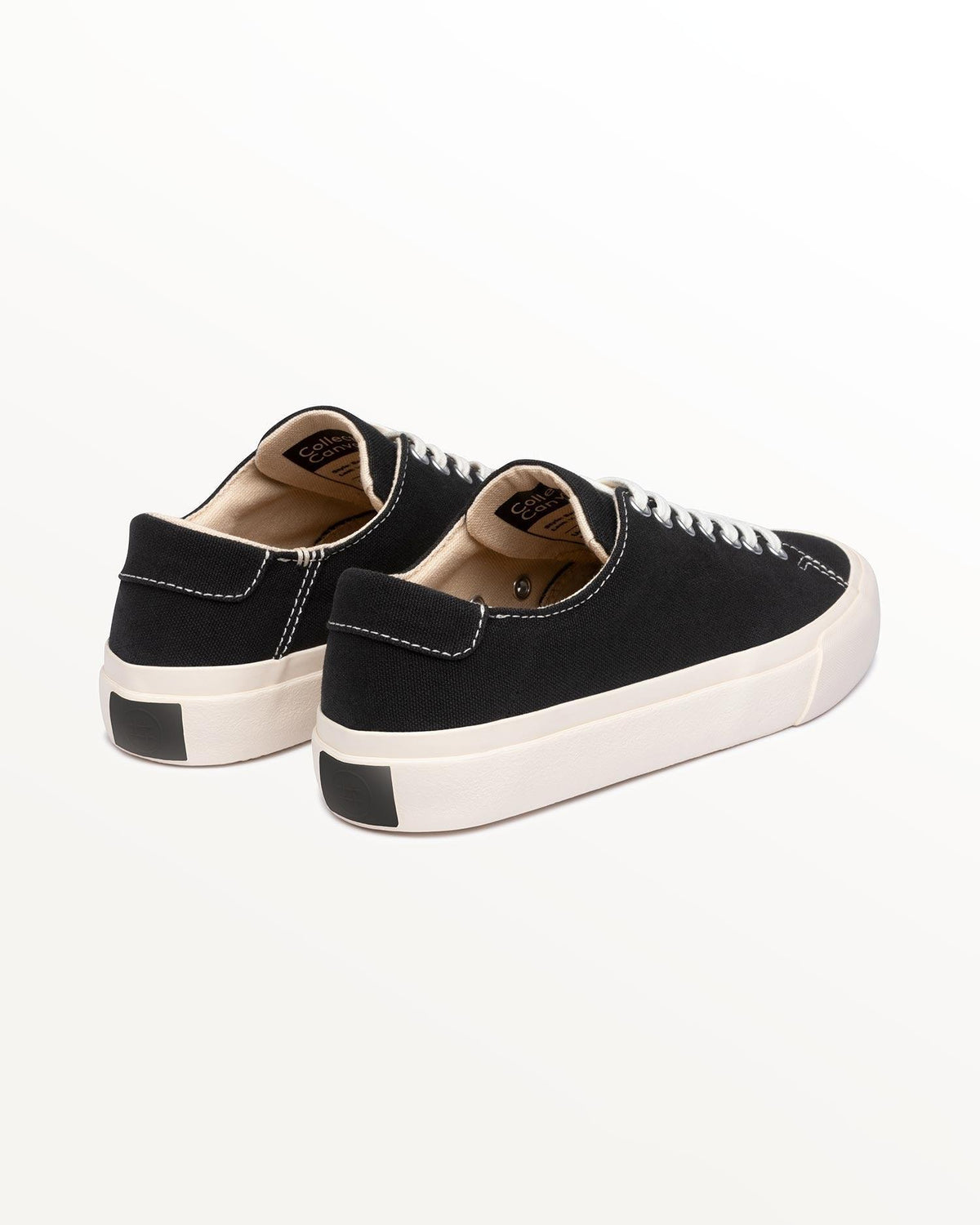 Baan Black/White trainers, three-quarter rear view showing black heel patch on off-white rubber sole