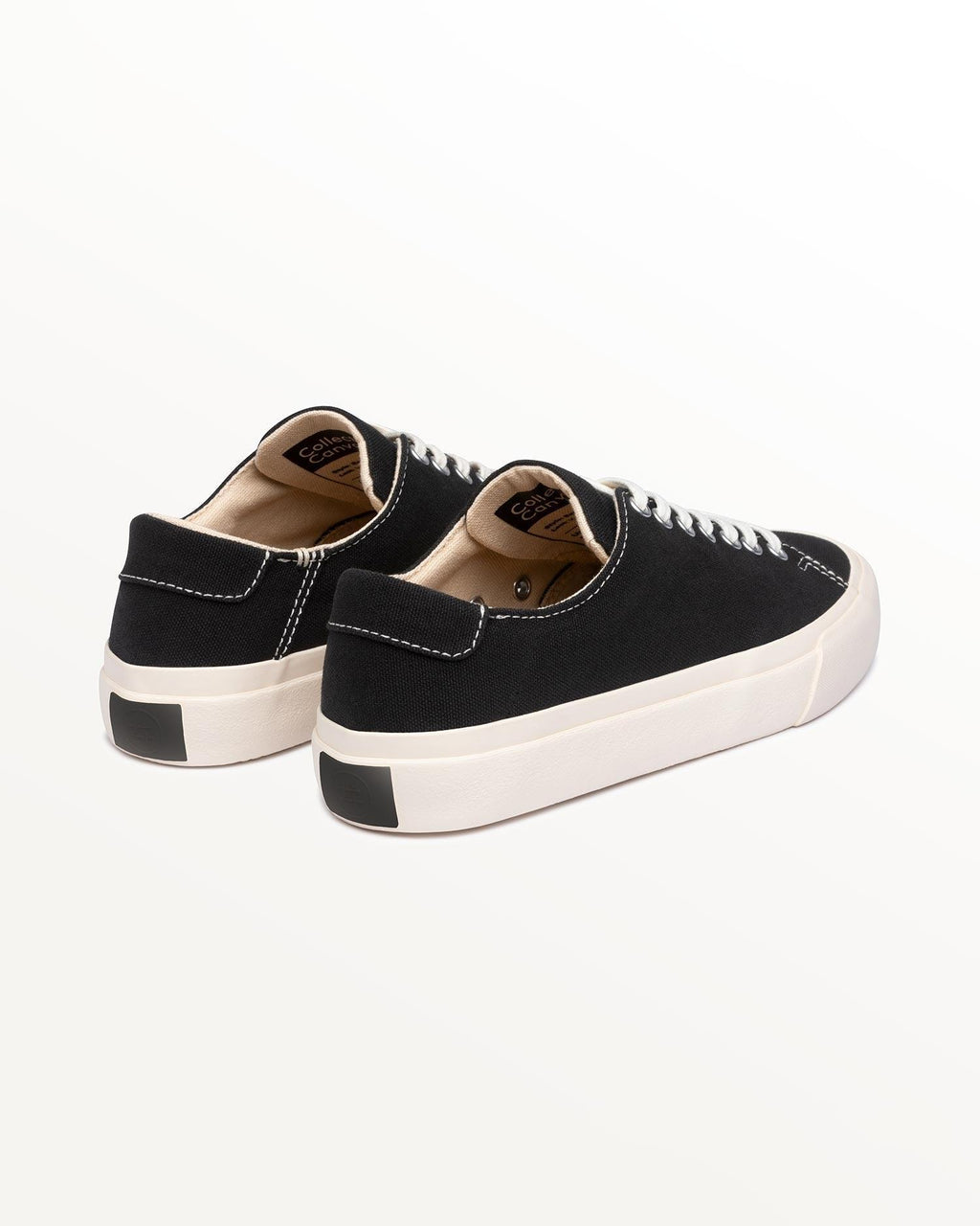 Baan Black/White trainers, three-quarter rear view showing black heel patch on off-white rubber sole