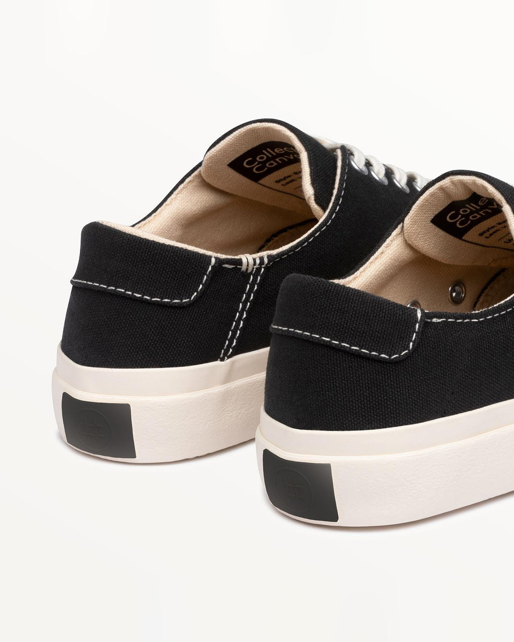 Close-up of Baan Black/White heels with white contrast stitching and black heel patch on the off-white sole