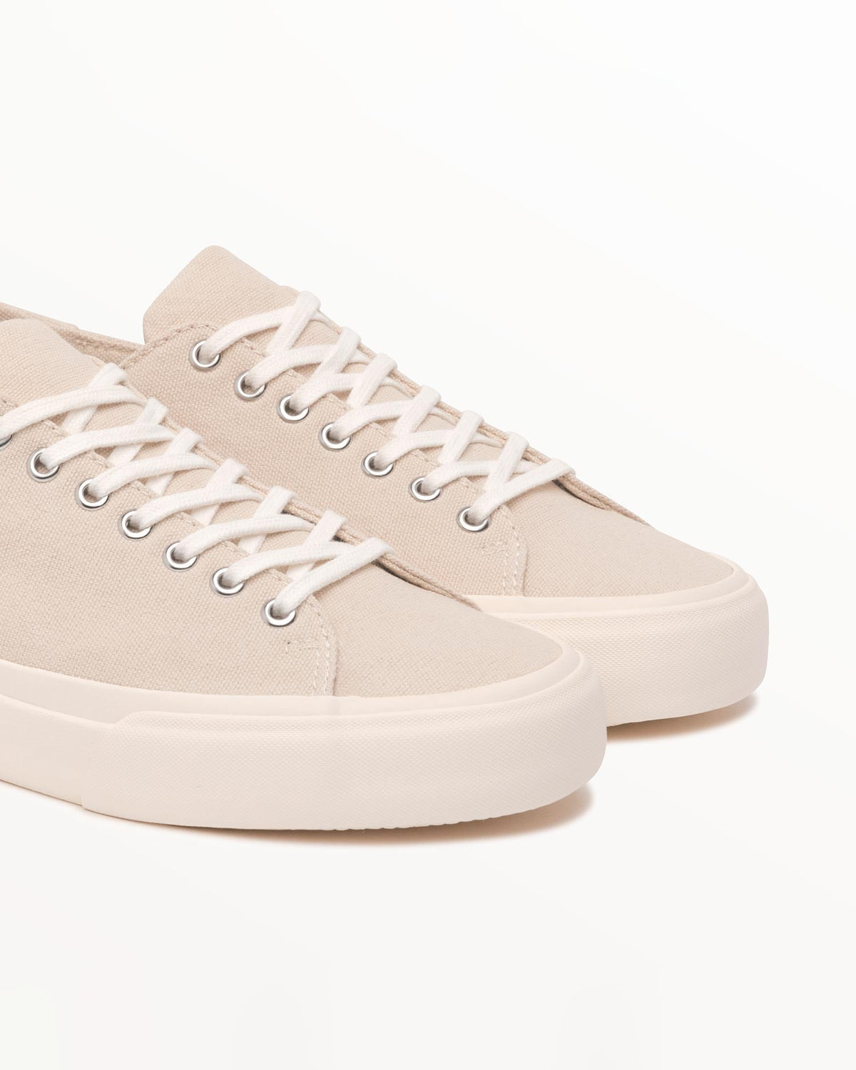 Close-up of natural organic cotton canvas upper and metal eyelets on Baan Natural