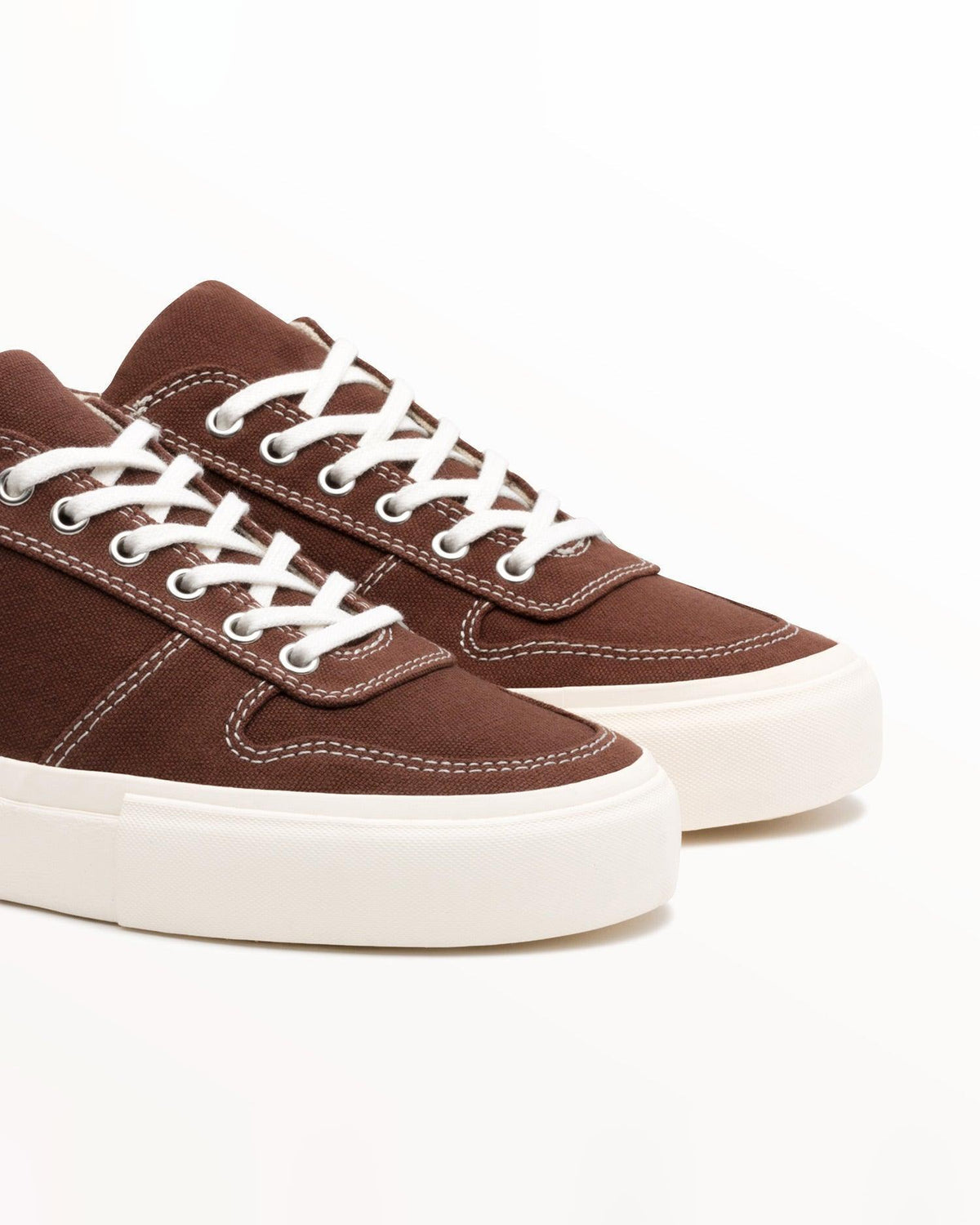 Close-up of brown organic cotton canvas upper with white stitching and laces on Bal Cappuccino