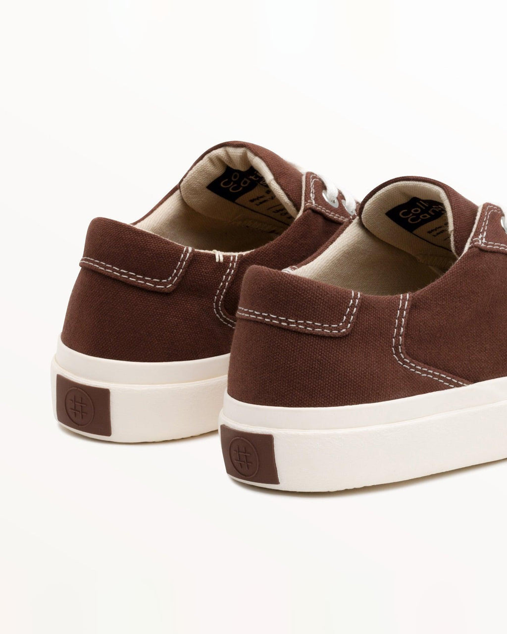 Close-up of Bal Cappuccino heel with stitched pull tab and brown heel patch on the off-white rubber sole