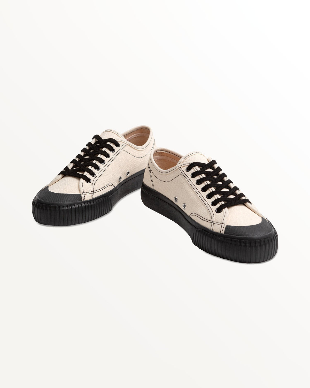 Pair of Buddy x CC Hemp Off-White/Black trainers with black rubber toe caps, angled front view