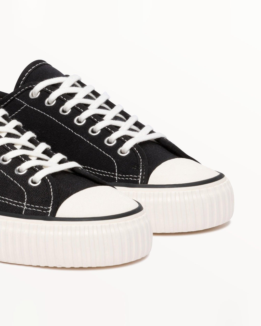 Close-up of black hemp canvas upper, white laces and metal eyelets on Straat Black/White