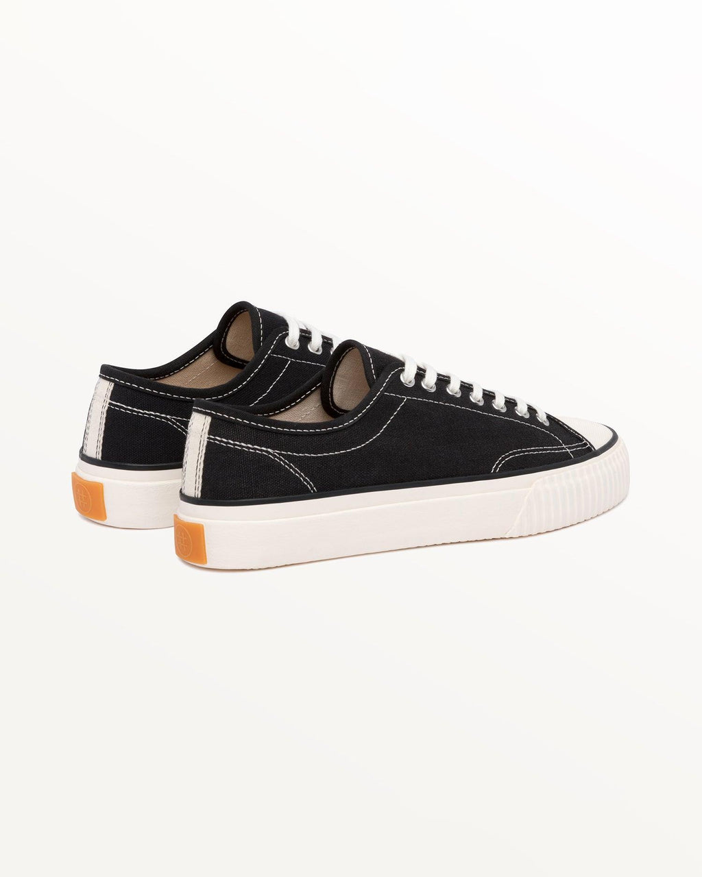 Straat Hemp Black/White trainers, three-quarter rear view showing orange heel tabs