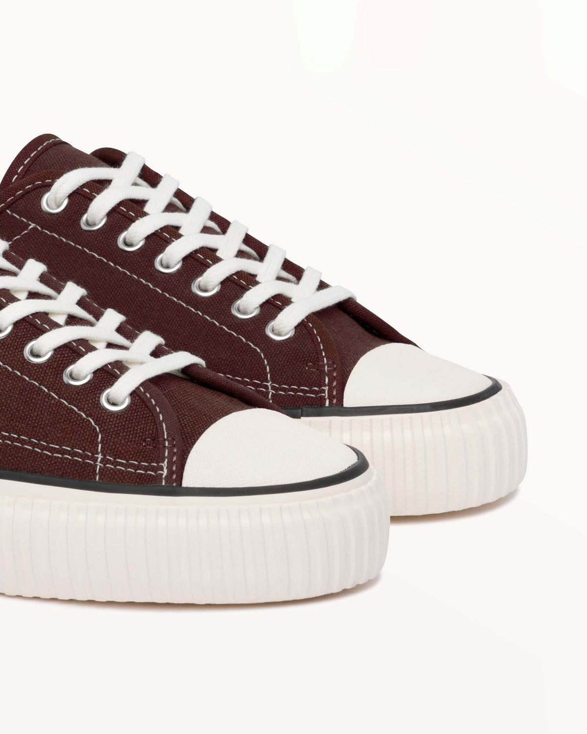 Close-up of brown hemp canvas upper, white laces and off-white rubber toe caps on Straat Coffee