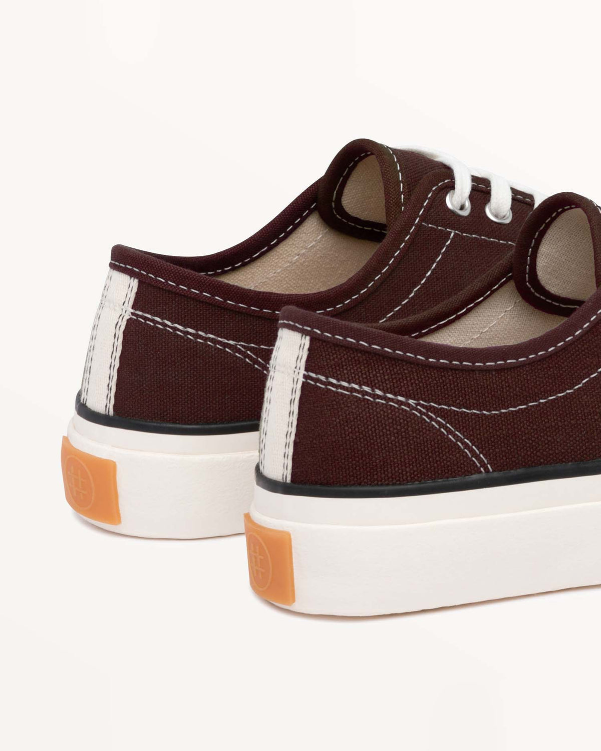 Close-up of Straat Coffee heels with cream heel stripe and orange heel tab