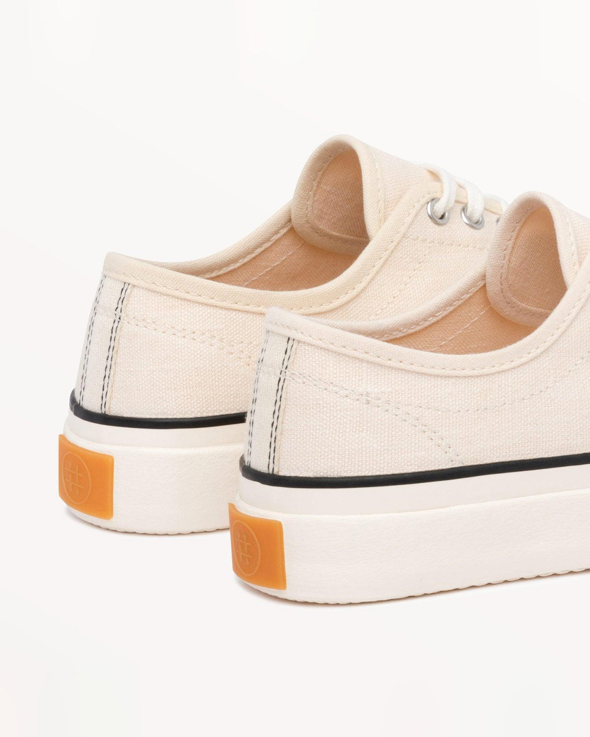 Close-up of Straat Natural/Black heels with orange heel tabs and black contrast stitching