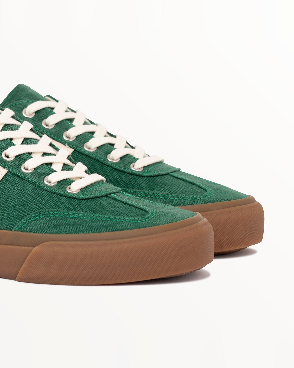Close-up of the green hemp canvas toe, metal eyelets and ecru laces on Veld Sage/Ecru
