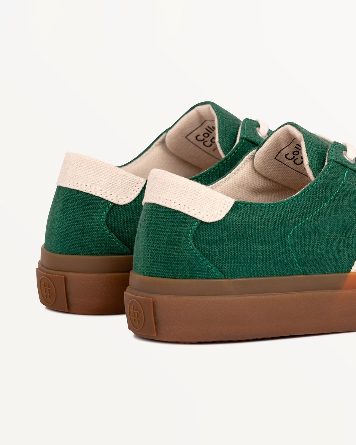 Close-up of Veld Sage/Ecru heel with ecru heel tab and embossed logo on the natural gum rubber sole